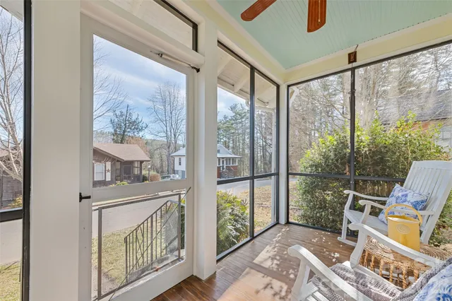 a view of a porch with furniture and front door