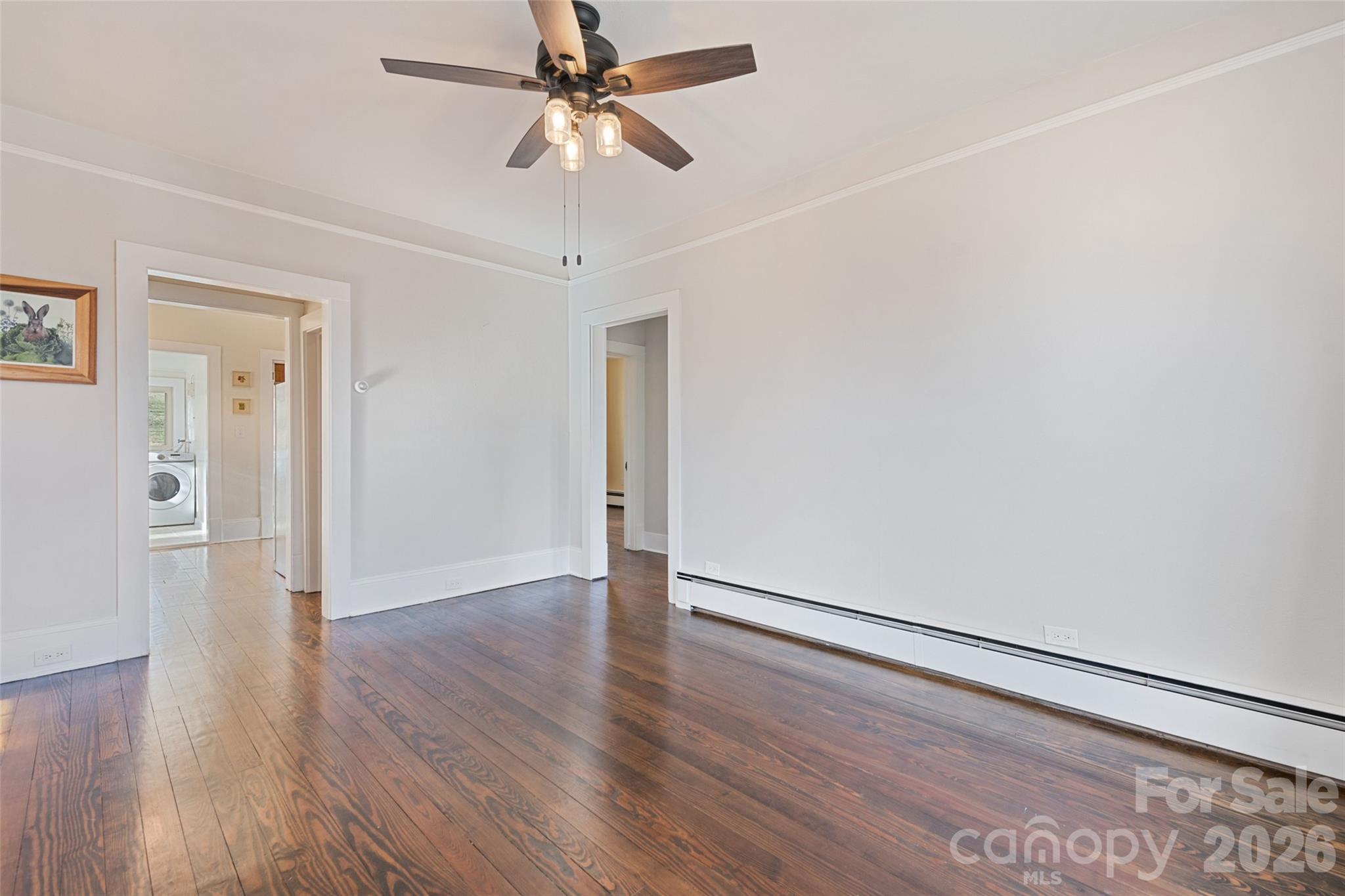 57 Fiddle Drive Canton, NC 28716 - Photo 10 of 35 an empty room with wooden floor chandelier fan and closet area