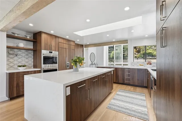 a kitchen with stainless steel appliances a sink stove and cabinets