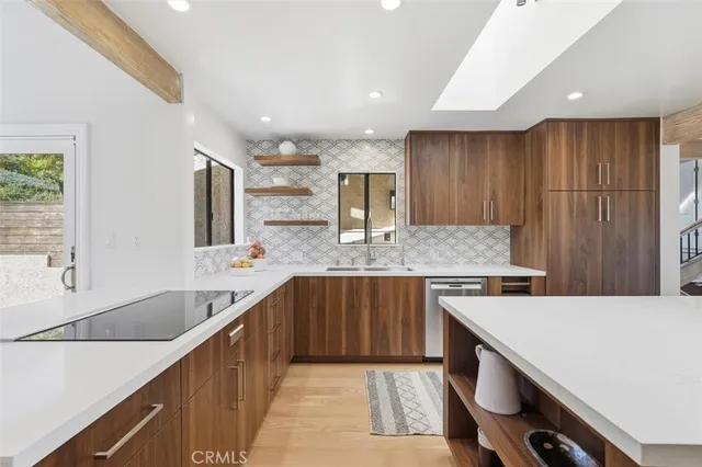 a kitchen with stainless steel appliances granite countertop a sink counter space cabinets and a large window