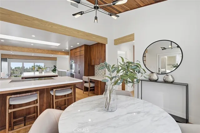 a kitchen with a table chairs and a chandelier