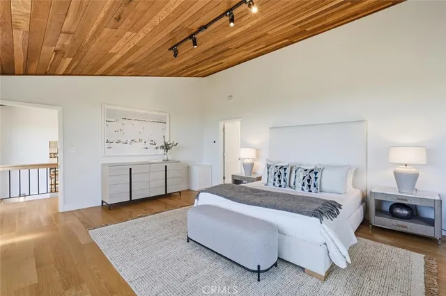 a spacious bedroom with a bed and a large window