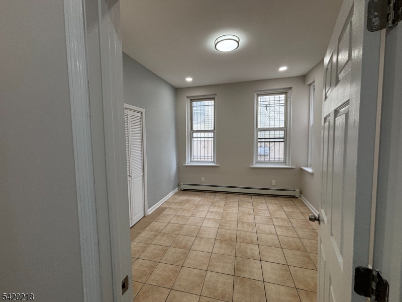 127 Fulton Street Elizabeth Port, NJ 07206 - Photo 12 of 21 a view of an empty room and window