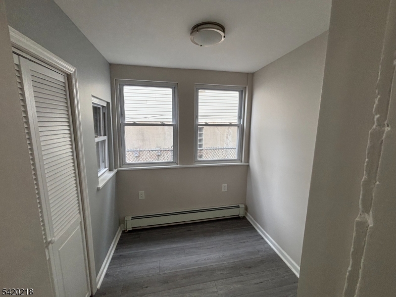 127 Fulton Street Elizabeth Port, NJ 07206 - Photo 17 of 21 a view of an empty room with wooden floor and a window