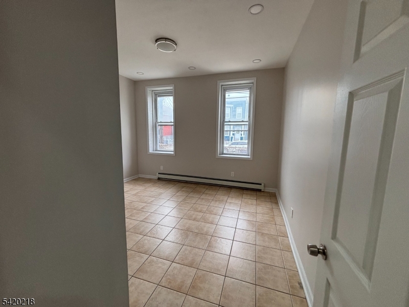 127 Fulton Street Elizabeth Port, NJ 07206 - Photo 18 of 21 a view of an empty room and window