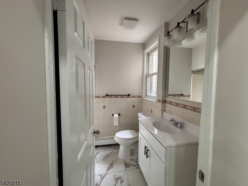 127 Fulton Street Elizabeth Port, NJ 07206 - Photo 20 of 21 a bathroom with a granite countertop sink toilet and shower