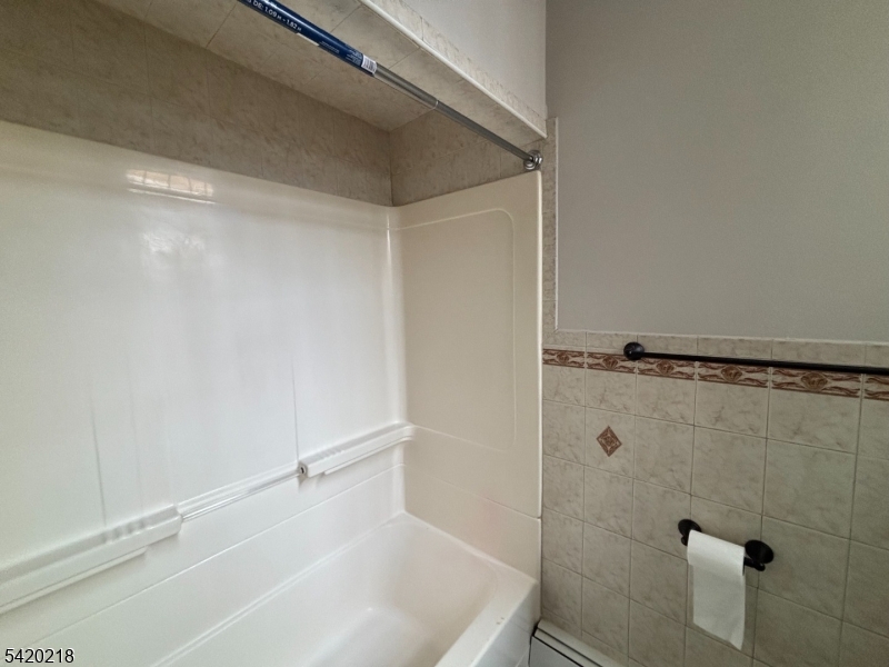 127 Fulton Street Elizabeth Port, NJ 07206 - Photo 21 of 21 a bathroom with a white bath tub