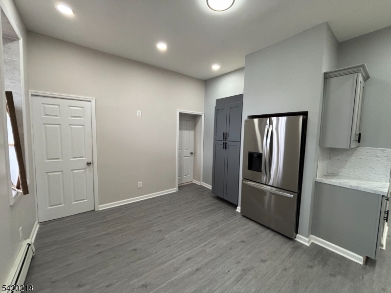 127 Fulton Street Elizabeth Port, NJ 07206 - Photo 3 of 21 an empty room with wooden floor and windows