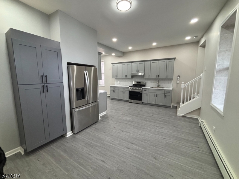 127 Fulton Street Elizabeth Port, NJ 07206 - Photo 4 of 21 a kitchen with stainless steel appliances a refrigerator sink and cabinets