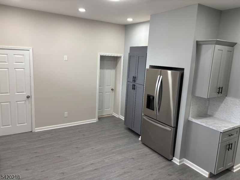 127 Fulton Street Elizabeth Port, NJ 07206 - Photo 5 of 21 a view of a kitchen with refrigerator and wooden floor