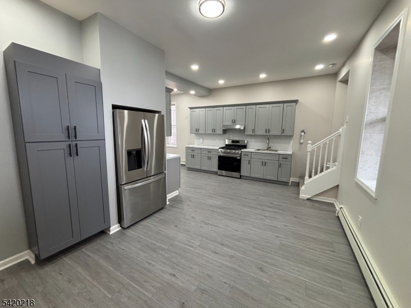 127 Fulton Street Elizabeth Port, NJ 07206 - Photo 6 of 21 a kitchen with stainless steel appliances granite countertop a refrigerator a sink and a stove