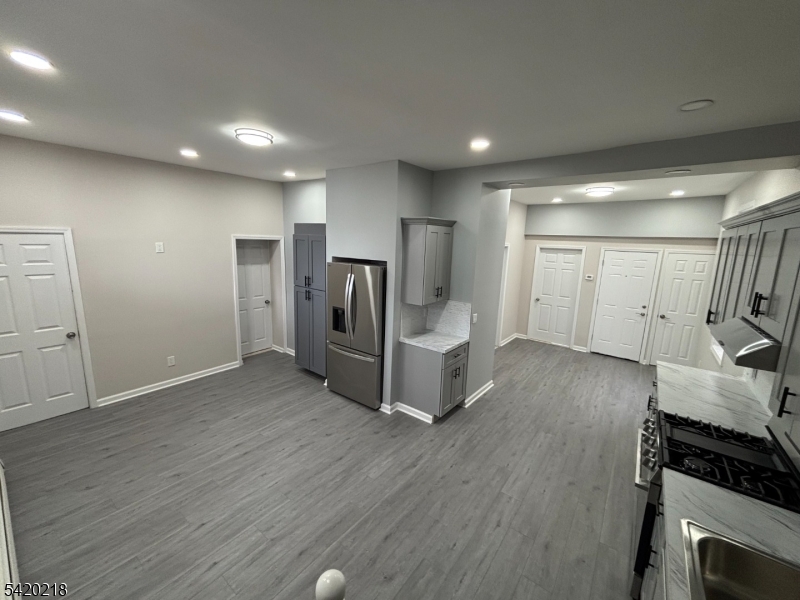 127 Fulton Street Elizabeth Port, NJ 07206 - Photo 8 of 21 a view of a kitchen with refrigerator and wooden floor