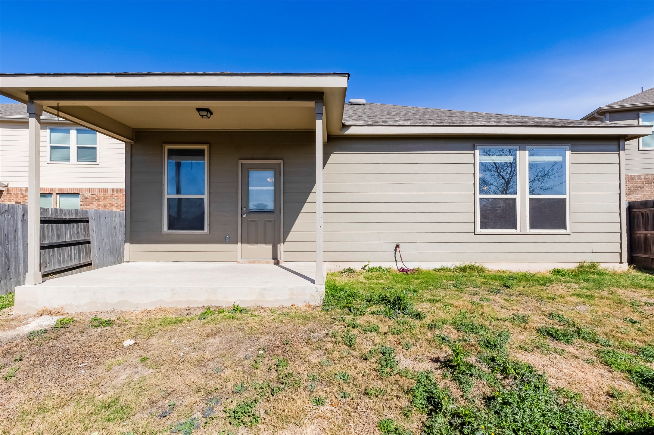 11617 Amber Stream Lane Manor, TX 78653 - Photo 23 of 39 Rear view of property featuring a fenced backyard, a patio area, and a shingled roof