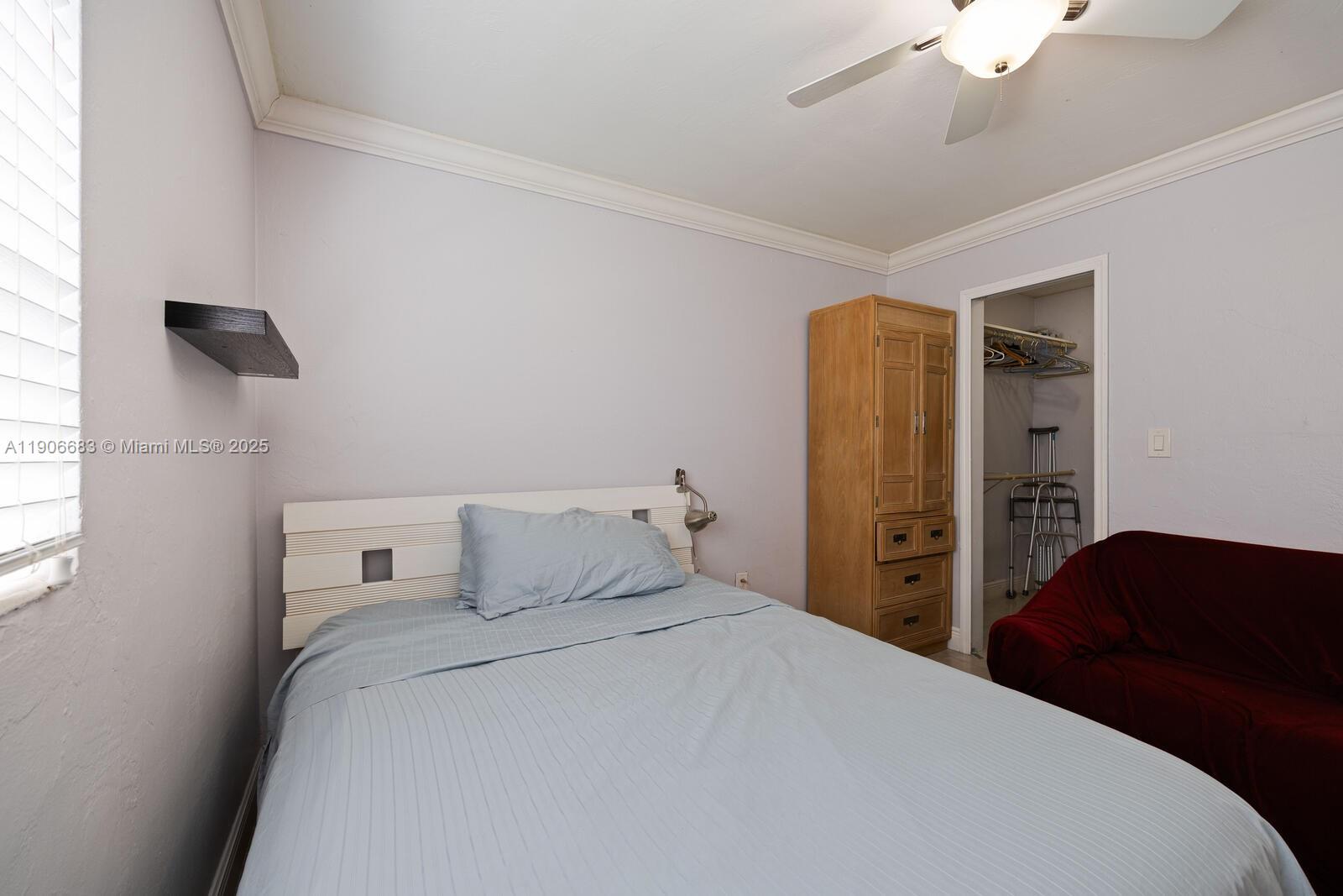 7401 Southwest 82nd Street, Unit 109S Miami, FL 33143 - Photo 13 of 21 a bedroom with a bed and a chandelier