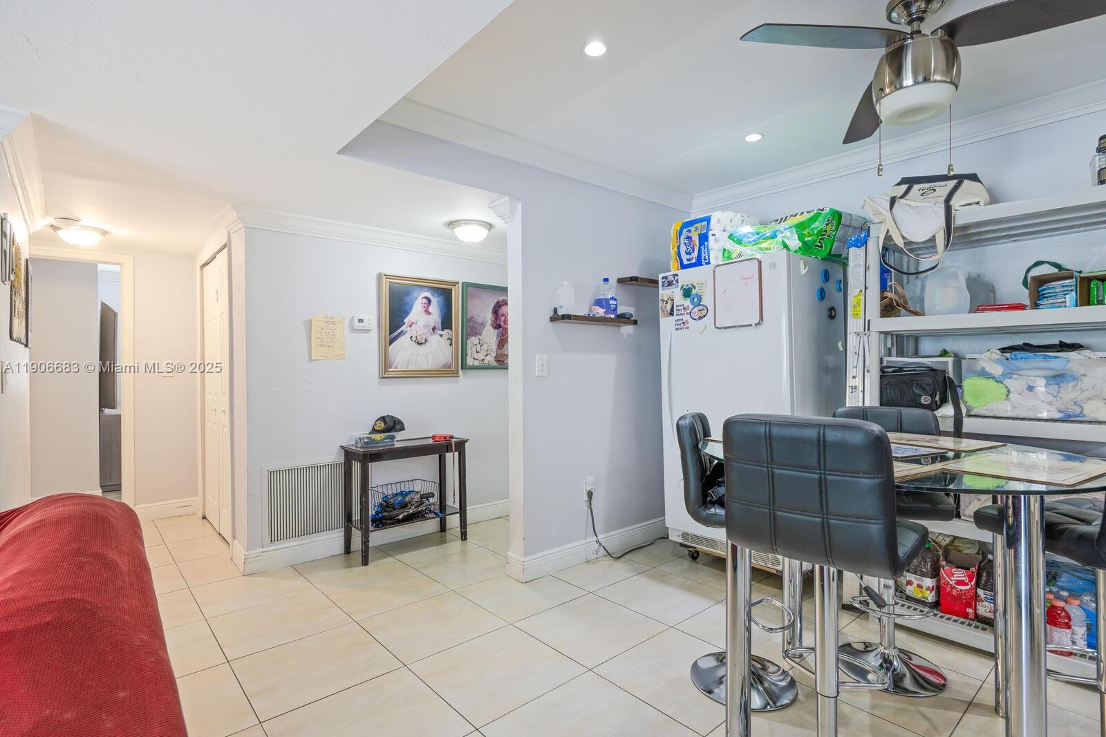 7401 Southwest 82nd Street, Unit 109S Miami, FL 33143 - Photo 5 of 21 a living room with furniture and a dining table with chairs