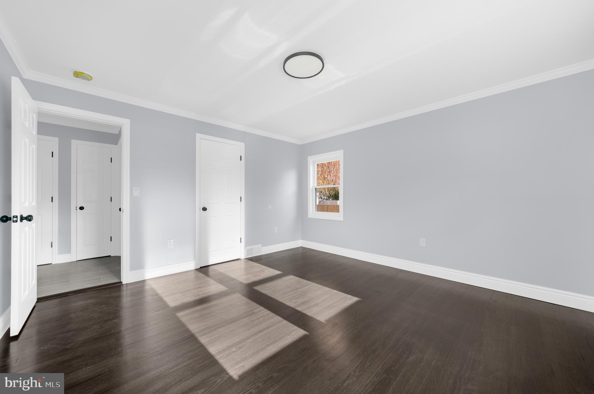 17 Ranchwood Drive Ewing, NJ 08618 - Photo 11 of 33 an empty room with wooden floor and windows