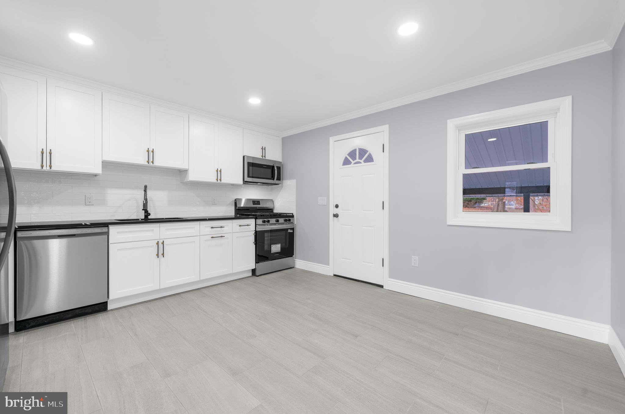 17 Ranchwood Drive Ewing, NJ 08618 - Photo 7 of 33 a kitchen with granite countertop white cabinets and white appliances