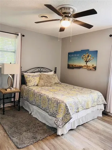 a bedroom with a bed and window