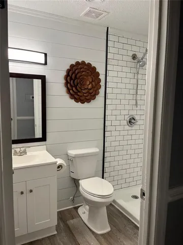 a bathroom with a toilet a sink and shower