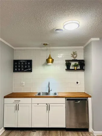 a kitchen with stainless steel appliances a sink a stove and microwave
