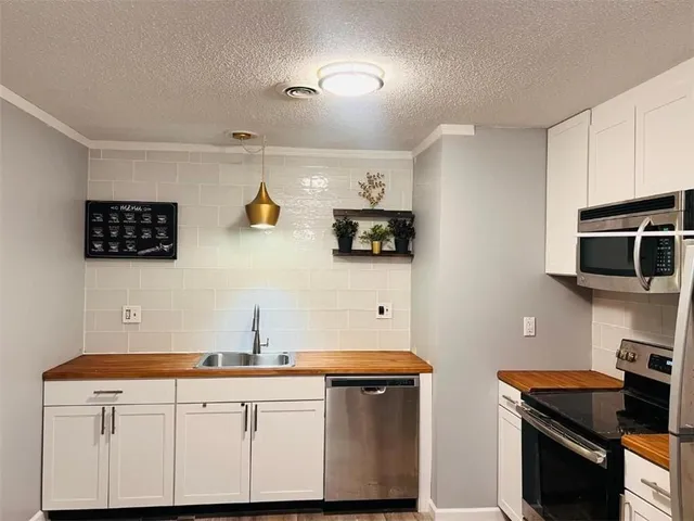 a view of a livingroom with furniture and bathroom