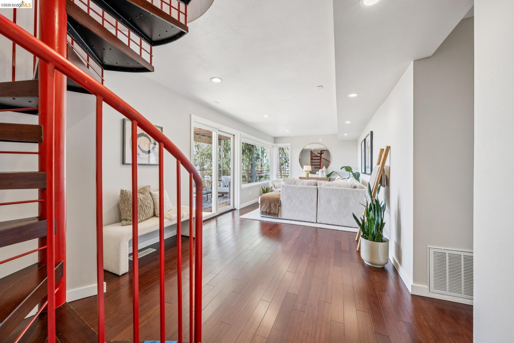 1394 Queens Road Berkeley, CA 94708 - Photo 36 of 63 Red spiral staircase, wood-finish flooring, recessed lighting, and sliding glass doors