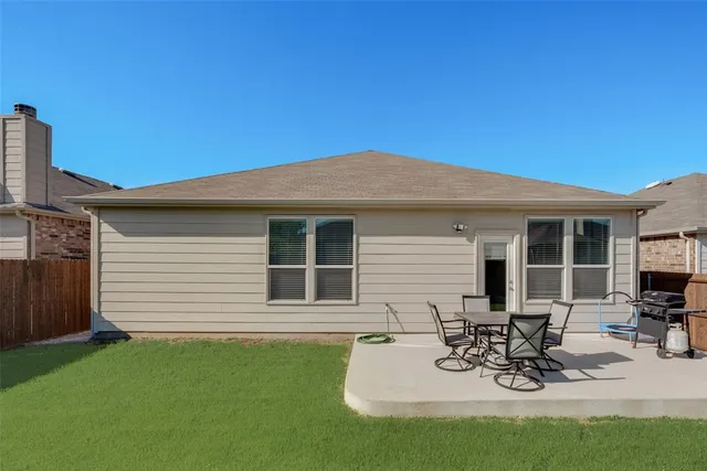 a view of a backyard with table and chairs and a yard