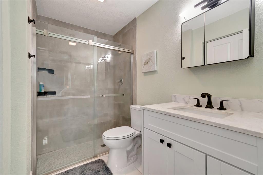 710 Southeast 3rd Avenue Delray Beach, FL 33483 - Photo 11 of 31 a bathroom with a granite countertop sink a toilet and shower