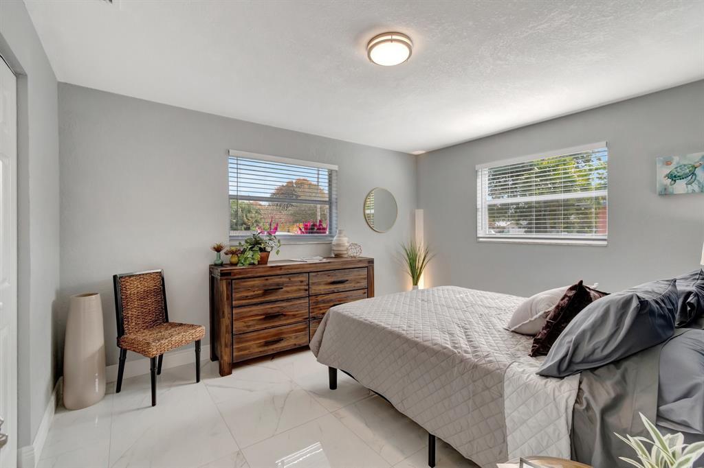 710 Southeast 3rd Avenue Delray Beach, FL 33483 - Photo 13 of 31 a bedroom with a bed and a window