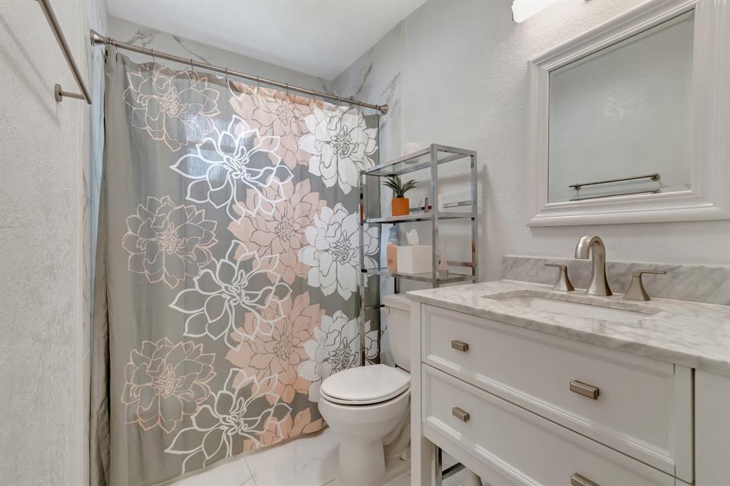 710 Southeast 3rd Avenue Delray Beach, FL 33483 - Photo 16 of 31 a bathroom with a granite countertop sink toilet and shower