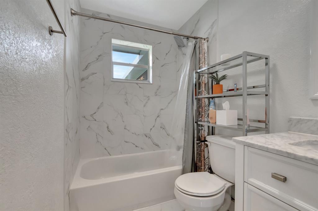 710 Southeast 3rd Avenue Delray Beach, FL 33483 - Photo 17 of 31 a bathroom with a sink a toilet and a bathtub