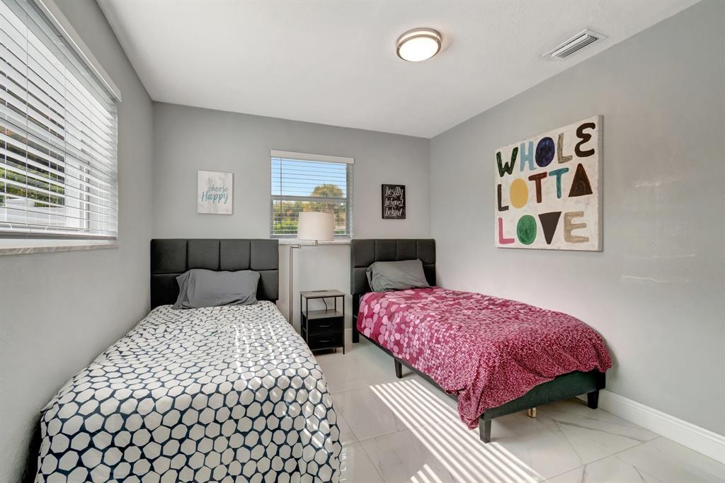 710 Southeast 3rd Avenue Delray Beach, FL 33483 - Photo 19 of 31 a bedroom with two beds and a dresser