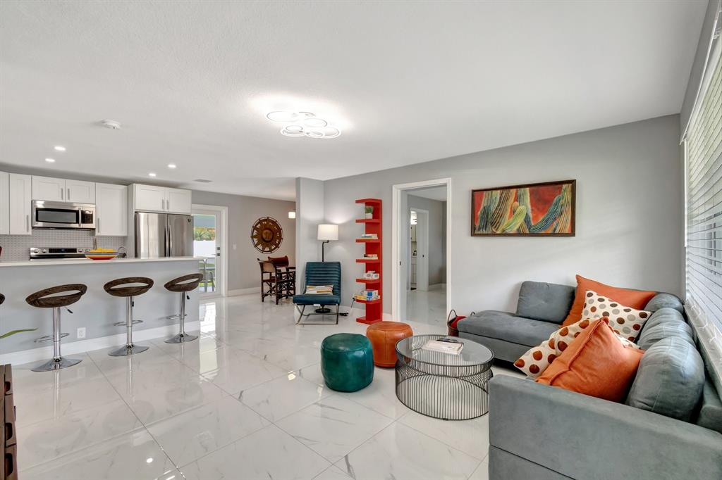 710 Southeast 3rd Avenue Delray Beach, FL 33483 - Photo 2 of 31 a living room with furniture and kitchen view