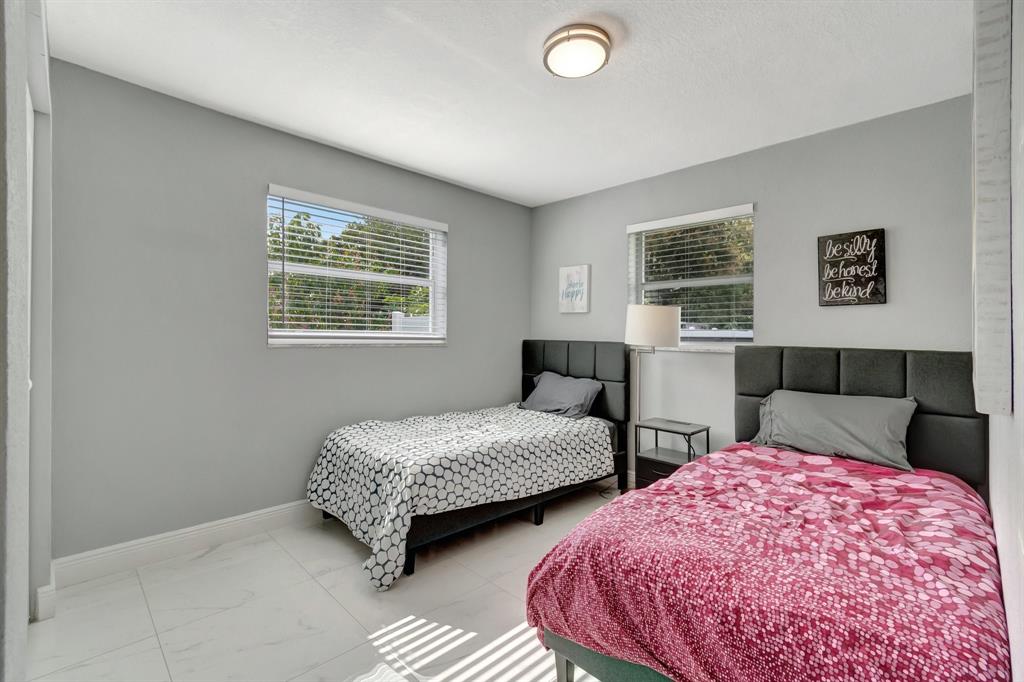 710 Southeast 3rd Avenue Delray Beach, FL 33483 - Photo 21 of 31 a bedroom with two beds and a window