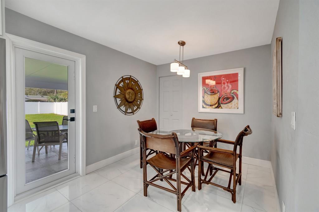 710 Southeast 3rd Avenue Delray Beach, FL 33483 - Photo 5 of 31 a view of a dining room with furniture and chandelier