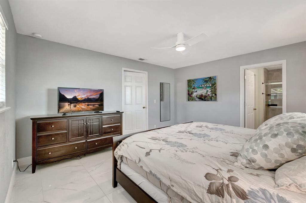 710 Southeast 3rd Avenue Delray Beach, FL 33483 - Photo 10 of 31 a bedroom with a bed and dresser