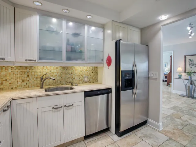a kitchen with stainless steel appliances granite countertop a refrigerator and a sink