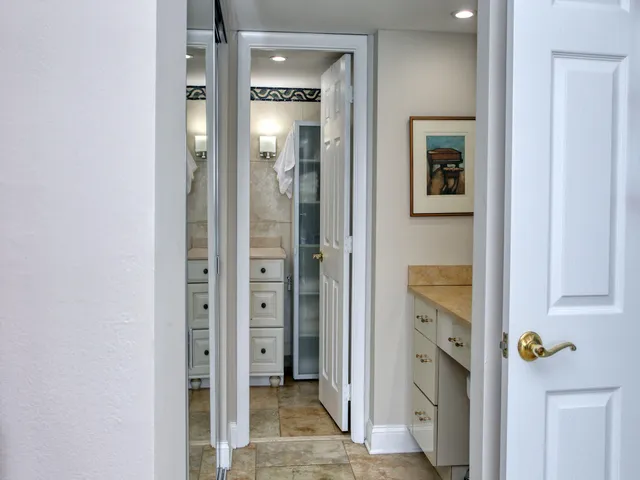 a bathroom with a granite countertop sink a mirror and shower
