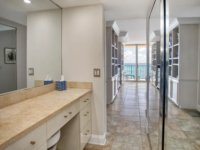 a bathroom with a granite countertop sink a toilet and shower