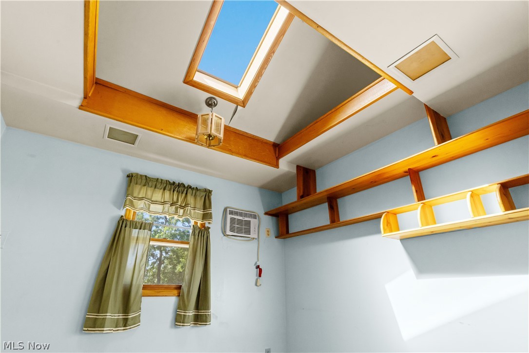 409 Edith Avenue Akron, OH 44312 - Photo 24 of 45 Vaulted ceiling featuring a prominent skylight and exposed wood beams