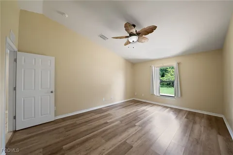 a view of room with hardwood floor and window