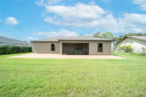 a front view of house with yard and green space