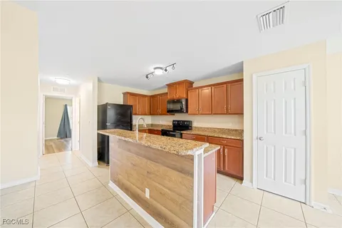 a kitchen with stainless steel appliances a refrigerator sink and cabinets