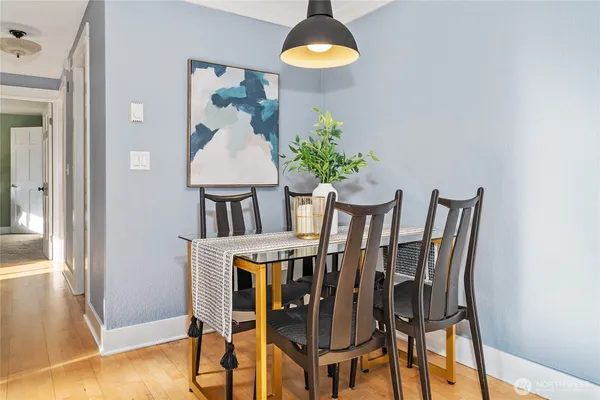 a view of a dining room with furniture and wooden floor