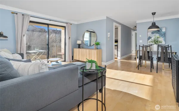 a living room with furniture and floor to ceiling windows