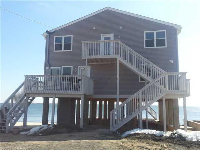 a view of a house with backyard and deck