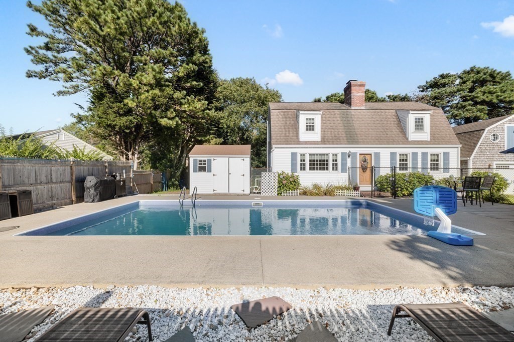 102 Williston Road Bourne, MA 02562 - Photo 3 of 32 a view of a swimming pool with a patio