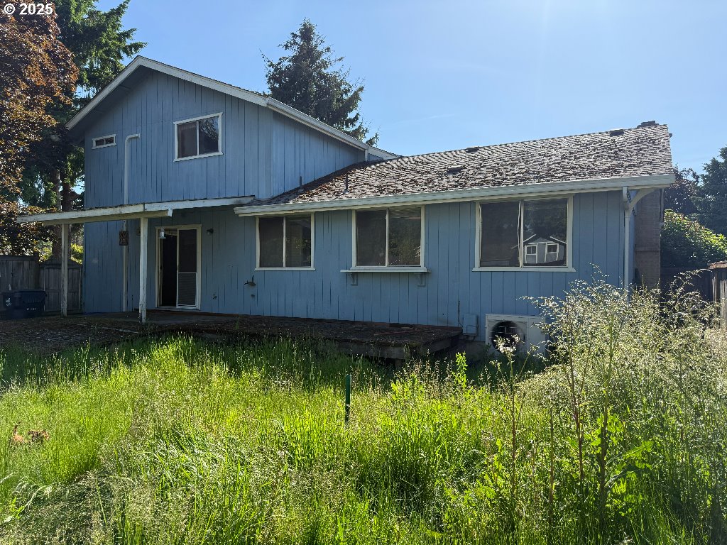 587 71st Street Springfield, OR 97478 - Photo 1 of 19 a view of a house with a yard plants and large tree