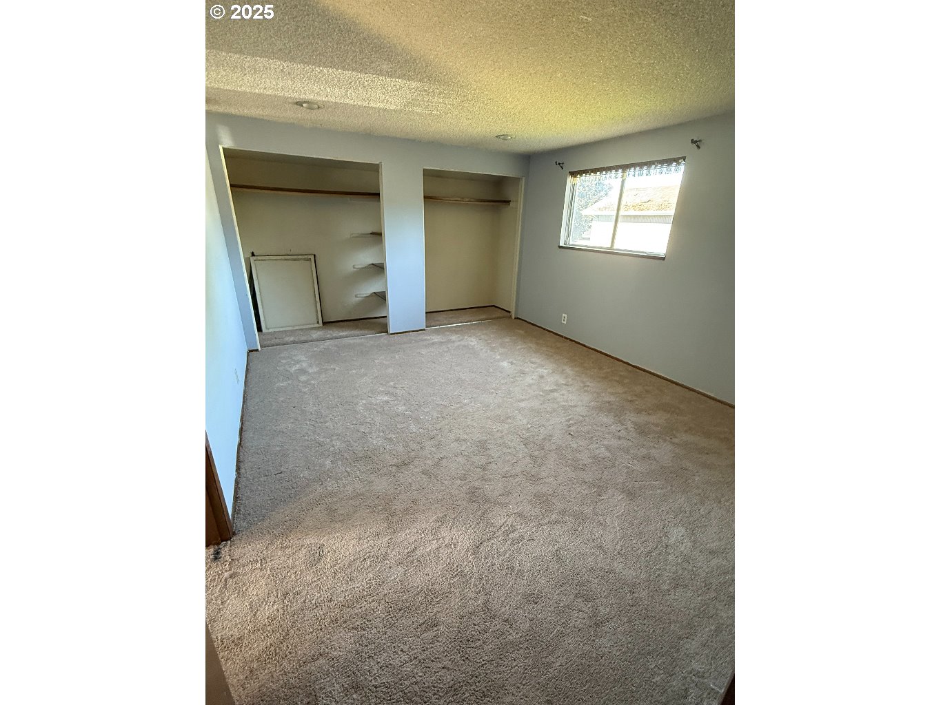 587 71st Street Springfield, OR 97478 - Photo 11 of 19 a view of an empty room with closet and a window