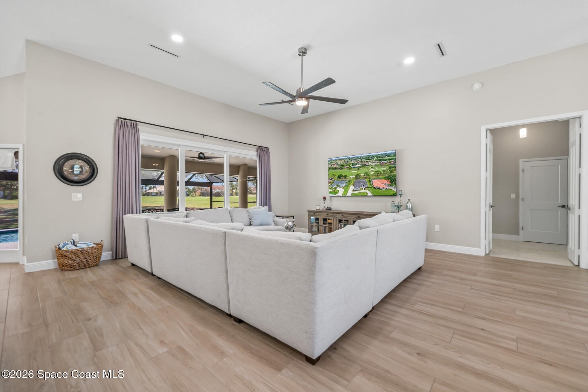 697 Spring Lake Drive Melbourne, FL 32940 - Photo 15 of 45 a living room with furniture and a wooden floor